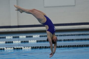 Action shot of Abigail Wilkov diving during a swim meet